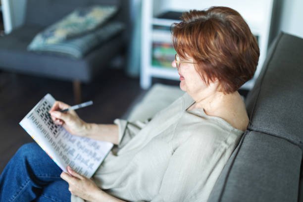 Caregiver and senior woman enjoying a puzzle together